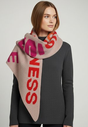 Knit scarf in blush pink with bold red and fuchsia lettering. Soft texture, triangular shape, draped elegantly around the neck.