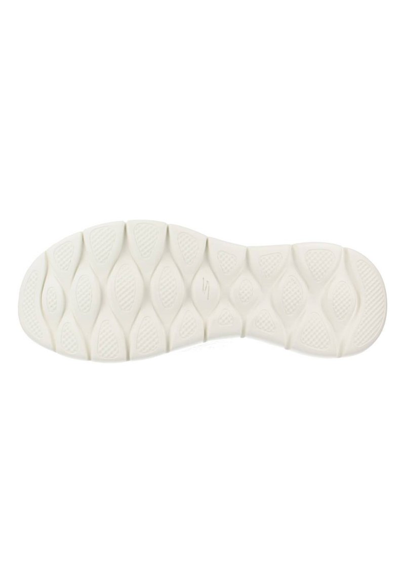 Suela de zapato de goma blanca con un patrón texturizado en forma de olas y pequeños nudos de agarre. Formas redondeadas distintivas mejoran la tracción.