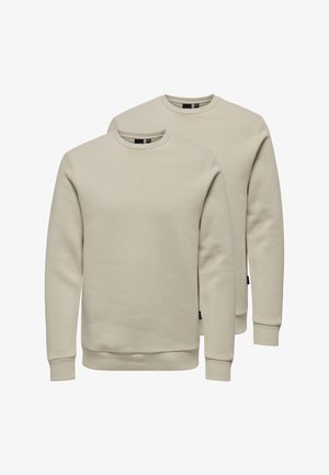 Deux sweat-shirts beiges en tissu doux, dotés de cols ronds, de manches longues et de bords côtelés aux poignets et à l'ourlet. Aucun motif ni logo visible.