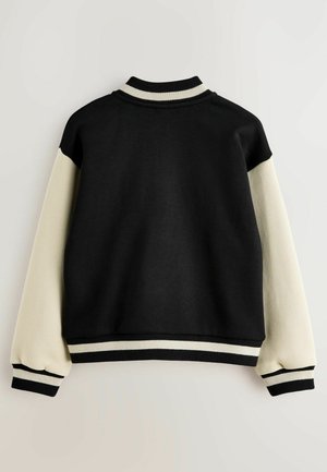 Black and cream sweatshirt with a cropped design, ribbed collar and cuffs, and contrasting sleeve color blocking. Soft textured fabric.