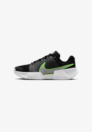 Nike athletic shoe featuring a black mesh upper with green and gray accents, a cushioned white outsole, and textured paneling along the sides.