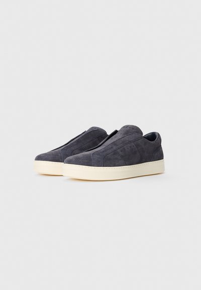 Pair of dark gray suede slip-on sneakers with thick white rubber soles, minimal stitching, and padded low-cut collars.