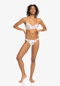 Floral Bikini-Set mit einem Bralette-Oberteil mit verstellbaren Trägern und tief sitzenden Bikinihosen, in Pink mit grünen und orangefarbenen Akzenten.
