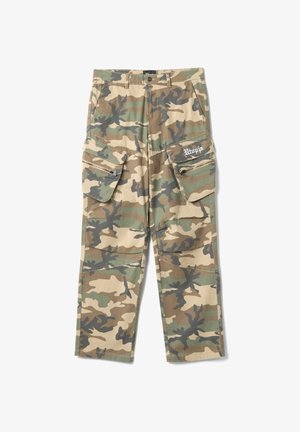 Camouflage cargo pants with side zipper pockets and flap pockets, featuring "Utopia" text on the right pocket flap.