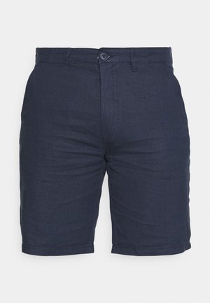 Shorts bleu marine en tissu texturé avec fermeture à bouton, présentant un devant plat et des poches latérales, conçus pour un ajustement décontracté.