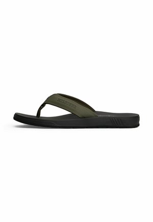 Men’s black sandal with olive green fabric thong strap, embossed brand name on strap, and textured sole, shown in side profile.