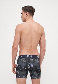 Fekete boxer alsónadrág, több mintás dizájnnal, Jordan logókkal. Stretch elasztikus derékpánt "JORDAN" felirattal fehér színben.