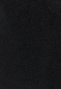 Tissu noir avec une surface lisse et légèrement texturée. Présente une couleur profonde et uniforme sans motifs ni quincaillerie visible.