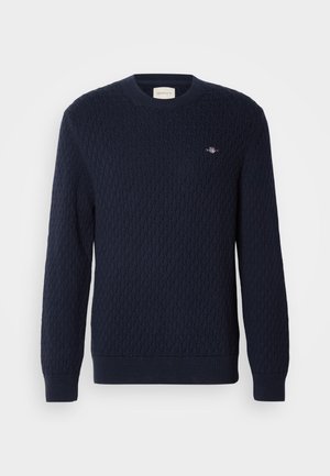 Marineblauer, gestrickter Pullover mit einem Diamantmuster, Rundhalsausschnitt und gerippten Bündchen. Kleines Logo auf der oberen linken Seite aufgestickt.