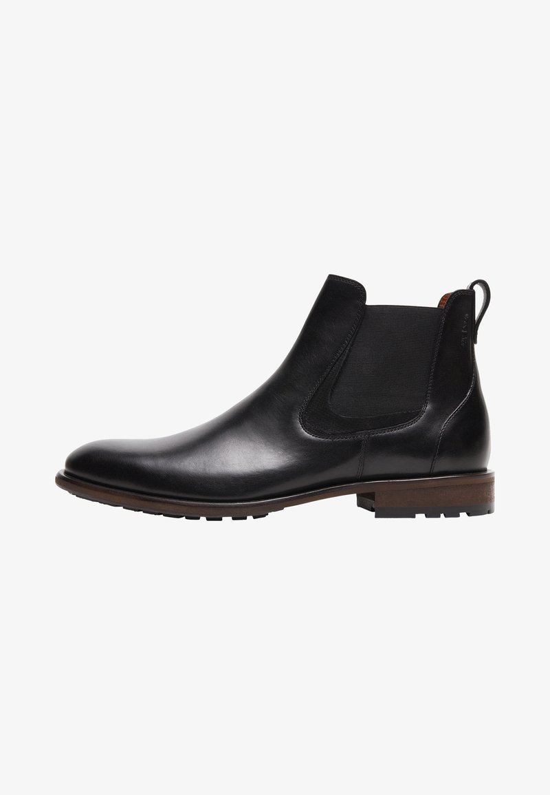 Botte Chelsea en cuir noir avec panneau latéral élastique, semelle marron et languette de tirage à la cheville, vue de profil tournée vers la gauche.