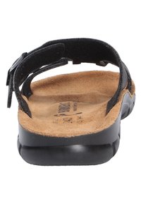 Black sandal with adjustable strap, textured sole, cork footbed, and a smooth black rubber bottom. Flat design for comfort and support.