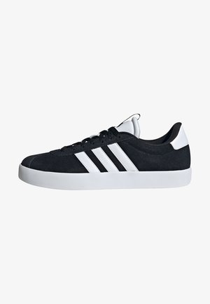 Black suede sneaker with white rubber outsole, three white stripes on the side, and a black and white padded collar.