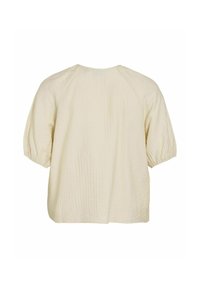 Camisa de tejido crema con un acabado texturizado, escote redondeado y mangas cortas abullonadas. Corte relajado con la parte trasera recta.