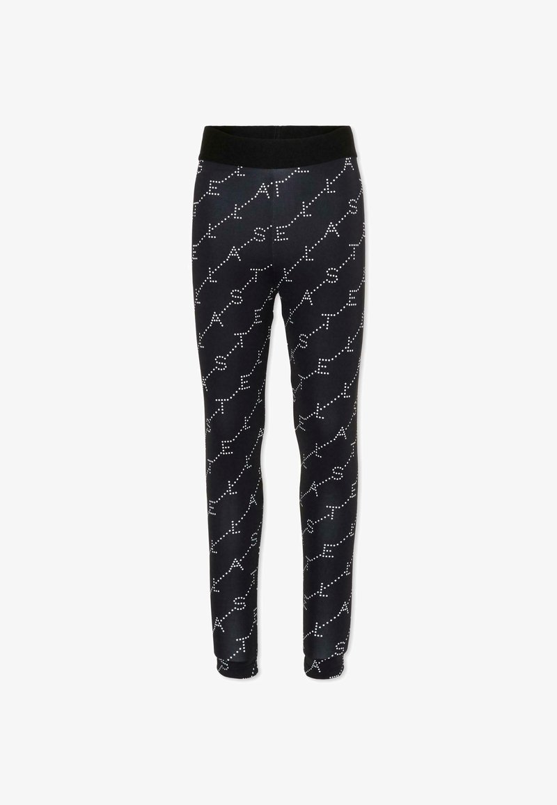 Pantalon noir ajusté avec des lettres blanches en points formant le mot "ASTEL" répété en diagonale sur le tissu.