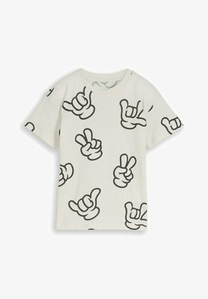 Biała koszulka z krótkim rękawem z czarnymi grafikami kreskówkowymi rąk pokazującymi znaki pokoju i shaka, rozrzucone po tkaninie.