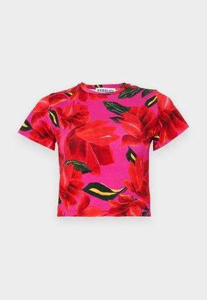 Short-sleeve, cropped t-shirt in pink fabric featuring large red floral prints and green leaves, round neckline, and soft texture.