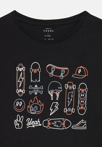 Black shirt with orange and white skateboard-themed icons including boards, helmet, cap, skull, peace sign, and the word "Yeah."