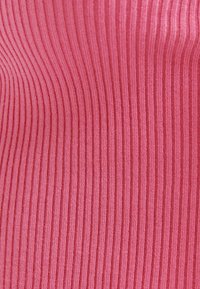 Ribbed fabric in light pink, featuring vertical stripes. Soft texture, with a consistent pattern and smooth finish.