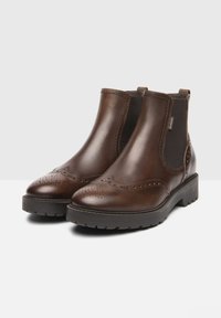 Brown leather ankle boots with elastic side panels, rounded toe, perforated detailing, and a chunky rubber sole for traction.