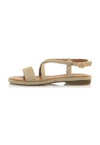 Sandali piatti intrecciati beige con design a tracolla e fibbia alla caviglia. Sottopiede in pelle liscia con una leggera superficie testurizzata.