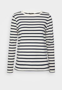 Langärmliges gestreiftes Hemd in Creme und Marineblau, aus weichem Stoff. Hat einen Rundhalsausschnitt und ein kleines Logo nahe dem Saum.