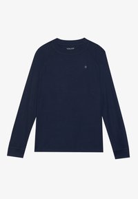 Cămașă lungă bleumarin cu guler rotund, mâneci raglan și un mic logo pe piept. Material moale cu detalii de cusătură în contrast.