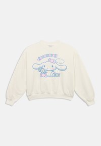Cream long-sleeve sweatshirt featuring a pastel blue and pink Cinnamoroll character holding candy with the text "cinnamoroll" above.