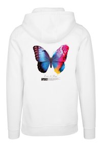 Sudadera blanca con un gran gráfico de mariposa multicolor en la parte posterior, con tonos azules, morados y rosas, y texto debajo de la imagen.