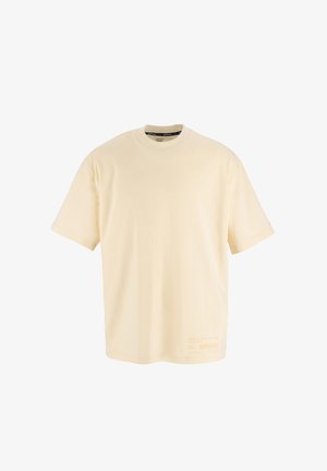 Cremfarbendes, übergroßes T-Shirt aus Baumwolle. Rundhalsausschnitt, kurze Ärmel, mit orangefarbigem Drucktext auf der unteren linken Seite. Glatte Textur.