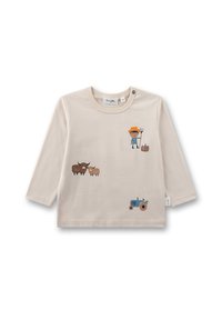 Beige Langarmhemd mit landwirtschaftlichen Grafiken: ein Kind mit einer Forke, zwei Kühe, ein Schaf und ein blauer Traktor. Weicher Baumwollstoff.