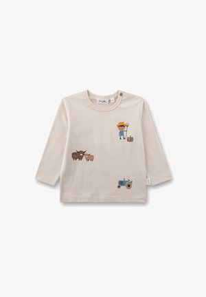 Beige long-sleeve shirt featuring farm-themed graphics: a child with a pitchfork, two cows, a sheep, and a blue tractor. Soft cotton texture.