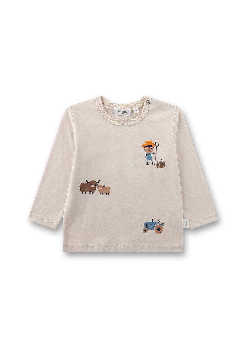 Beige Langarmhemd mit landwirtschaftlichen Grafiken: ein Kind mit einer Forke, zwei Kühe, ein Schaf und ein blauer Traktor. Weicher Baumwollstoff.
