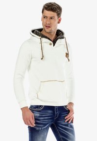 White pullover hoodie with a drawstring, buttoned neck, and patterned inner lining. Features a front pocket and beige stitching accents.