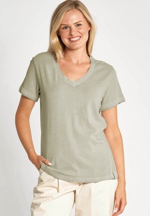Olive green, short-sleeve V-neck t-shirt made of soft fabric; features rolled sleeves and a relaxed fit with side hem accents.
