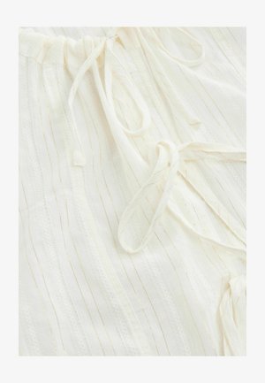 Schnürzug, leichtes, cremefarbenes Material mit vertikalen goldenen Streifen. Verfügt über eine Spitzenborte und zwei Stoffbindungen an der Taille. Glatte Textur.