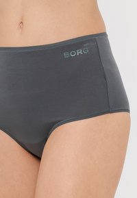 Szürke, magas derekú fehérnemű sima textúrával, amelyen a front derékpánton egy diszkrét, sötétzöld "BORG" embléma található.