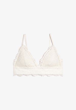 Bralette en dentelle couleur crème, avec une forme triangulaire, des bords festonnés, des bretelles réglables et une large bande en dentelle sous la poitrine.