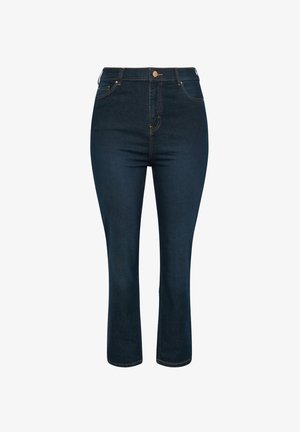 Tummansininen farkkukangas, korkea vyötärö, kullankeltaiset tikit ja suora lahkeensuun malli, joka päättyy juuri nilkan ylle. Klassinen viiden taskun muotoilu.