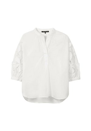 White loose blouse with three-quarter sleeves featuring floral lace cutouts and a round neckline with a partial front placket.