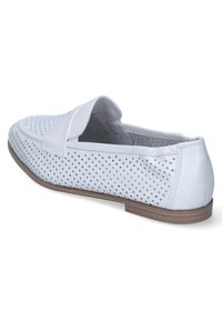 White leather slip-on shoe with perforated design, flat brown sole, rounded toe, and stitching accents. Interior lined in gray fabric.