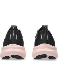 Black athletic sneakers with mesh fabric upper, pink rubber sole, and textured heel details. Features pull tabs for easy wear.