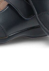 Zapatos de cuero negros con punta redondeada, detalles texturizados en la parte frontal y suela de goma plana. Correa ajustable para un ajuste seguro.