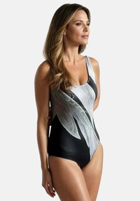 Eén-piece zwemoutfit met een zwarte basis en een groot wit en groen bladpatroon. Gladde, rekbare stof, ronde hals en brede schouderbanden.