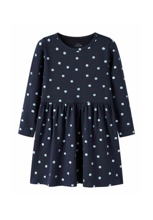 Marineblaues Langarmkleid mit hellblauen Punkten, ausgestattet mit einem runden Ausschnitt, geraffter Taille und einem schwingenden Rock. Aus weichem Baumwollstoff.