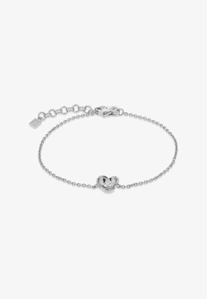 Bracelet en chaîne argentée avec un petit pendentif en forme de fleur et une pierre précieuse claire au centre, doté d’un fermoir ajustable.