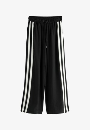 Black wide-leg pants with an elastic waistband and drawstring. Features three vertical white stripes on each side. Soft, smooth fabric texture.