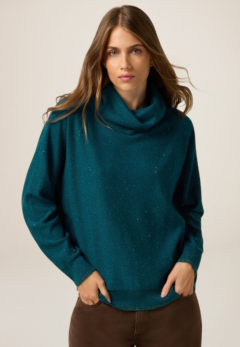 Türenfarbener Schalkragenpullover aus weichem, strukturiertem Stoff mit dezentem Glitzereffekt, ausgestattet mit langen Ärmeln und einer lockeren Passform.