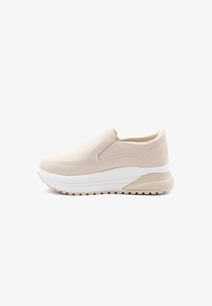 Beige slip-on sneakers with a smooth leather upper, thick white sole, and light tan accents. Rounded toe and cushioned interior design.