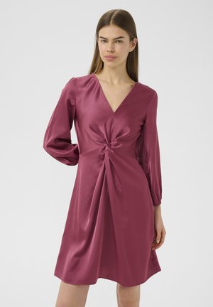 Knee-length dress in deep rose, made from satin. Features a V-neck, long puff sleeves, and a twisted knot detail at the waist. Smooth texture.