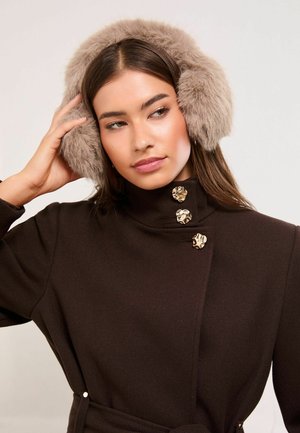 Faux fur ear muffs in light taupe, featuring a soft, fluffy texture. Brown coat with a high collar and three decorative gold buttons.